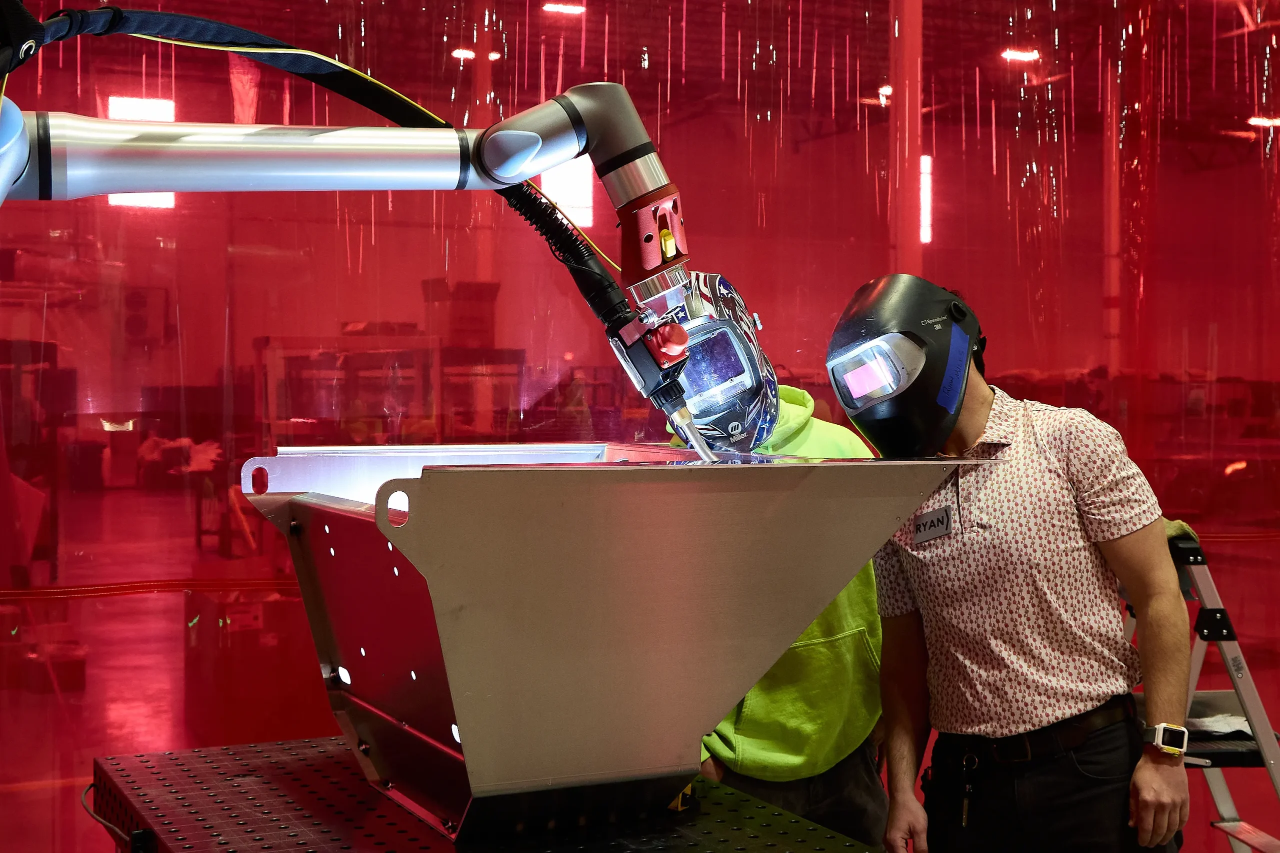 Technician overseeing robotic precision welding at the Flamingo factory